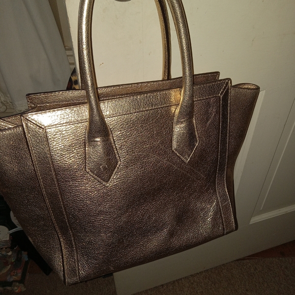 Henry Bendel Large Gold Metallic Bag with attached cross...